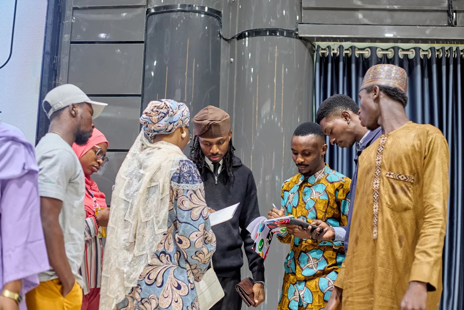After the talk: Godson with a group of attendees, looking at notes and phones together